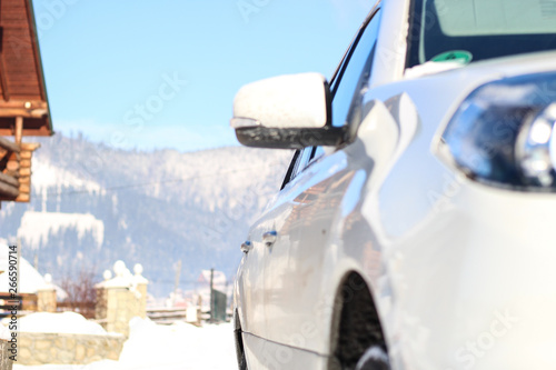 The car is white in the snow. Rubber on wheels in the snow. Snowy mountains of the Carpathians