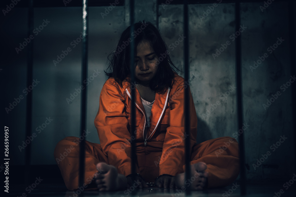 Portrait of women desperate to catch the iron prison,prisoner concept,thailand people,Hope to be free,If the violate the law would be arrested and jailed. Portrait of women desperate to catch the iron prison,prisoner concept,thailand people,Hope to be free,If the violate the law would be arrested and jailed.