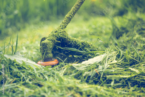 Cutting grass with a professional grass trimmer