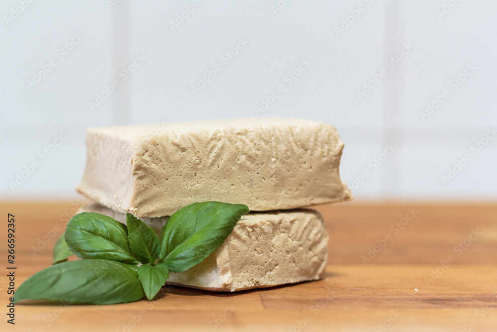 White tofu and basil on wooden board White tofu and basil on wooden board