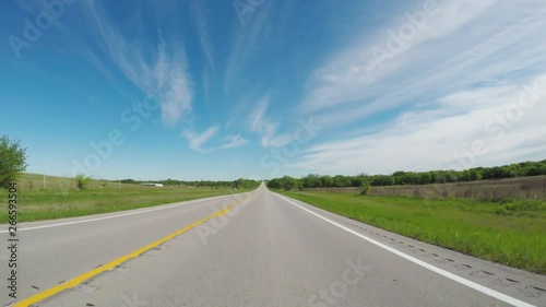 POV. Point of view countryside in the springtime.  View of beautiful open green areas beside the  road.