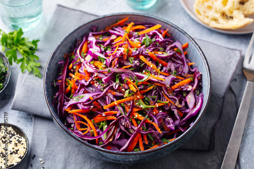 Tableau sur toile Red cabbage salad. Coleslaw in a bowl. Grey background. Close up.