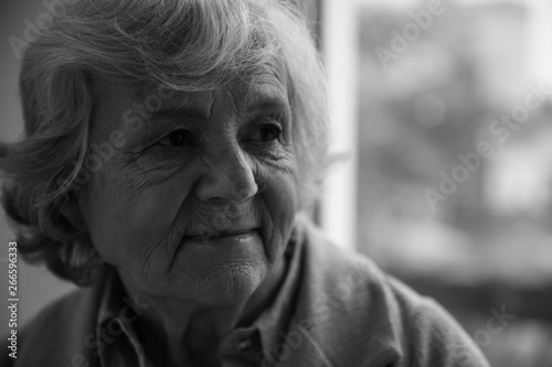 Portrait of elderly woman indoors, space for text. Black and white effect © New Africa
