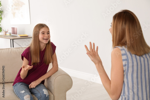 Mother talking with her teenager daughter at home
