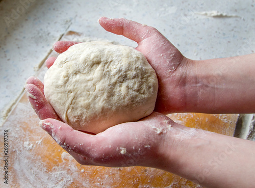dough in woman baker's hands