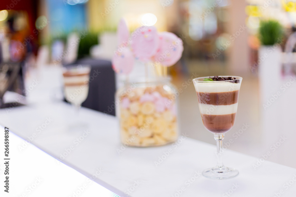Tasty chocolate And milk pudding and jar of homemade cookies on white background of bar counter Light low-calorie dessert for breakfast. Tasty chocolate And milk pudding and jar of homemade cookies on white background of bar counter Light low-calorie dessert for breakfast.