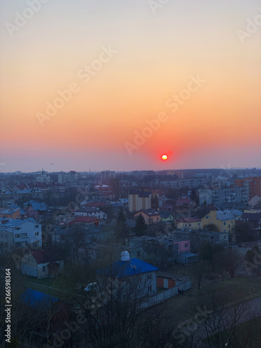 Panoramic windows overlooking beautiful golden sunset. View from home window