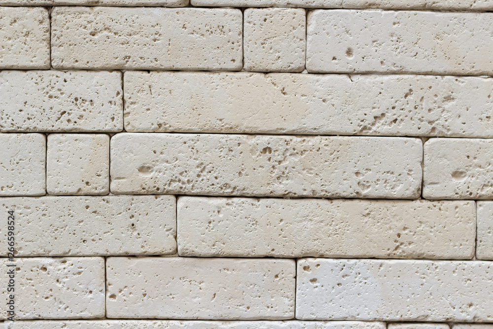 White stone brick wall tiles surface, close-up exterior background White stone brick wall tiles surface, close-up exterior background