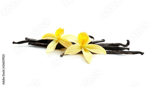 Aromatic vanilla sticks and flowers on white background