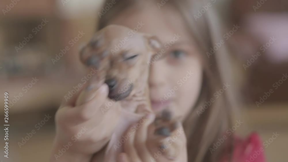 Close up portrait little pretty happy girl holding a cute chihuahua puppy and playing with him in living room. Close up portrait little pretty happy girl holding a cute chihuahua puppy and playing with him in living room.
