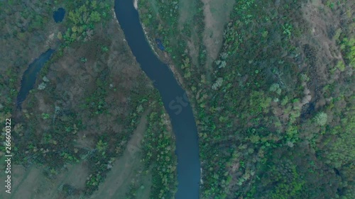 Sunny summer landscape with river.Green hills,fields and meadows.River Medvedica in Volgograd region,Russia.Sunrise.Quiet morning.Calm.Warm sunlight.Cloudless clear blue sky. 