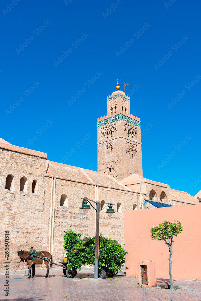 Donkey and Cart in front of the Minaret of Koutoubia Mosque in Marrakech Morocco