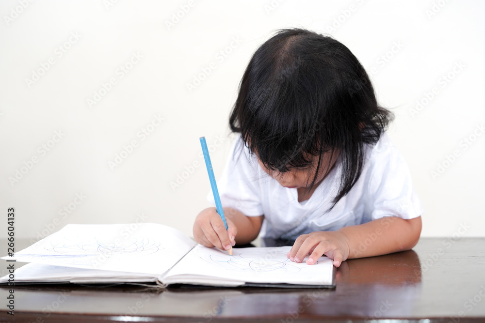Kid Asian student doing homework .Kid enjoy learning with happiness at home. Education concept. Kid Asian student doing homework .Kid enjoy learning with happiness at home. Education concept.