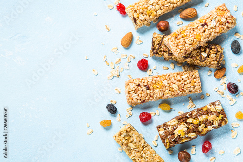 Konstfotografi Granola bar with nuts, fruits and berries on blue.