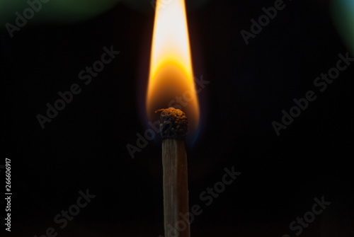 burning match on black background