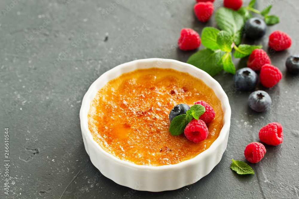 Creme brulee. dessert with caramel crust and berries.