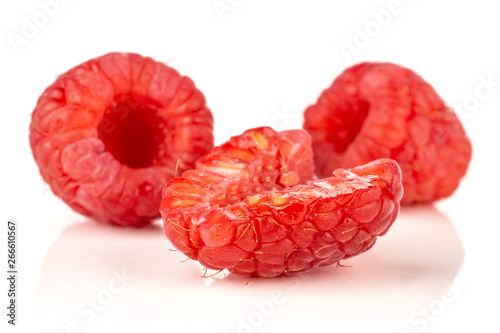 Group of two whole one half of fresh red raspberry isolated on white background