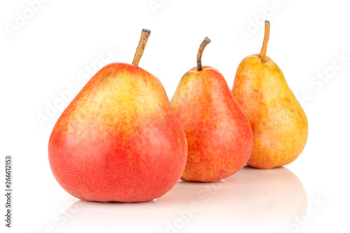 Group of three whole fresh red pear in row isolated on white background