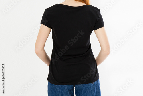 back view t-shirt design, happy people concept - smiling red hair woman in blank black t-shirt pointing her fingers at herself, red head girl tshirt mock up