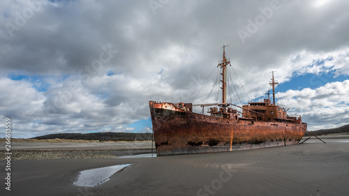 Huge aground boat on the beach photo