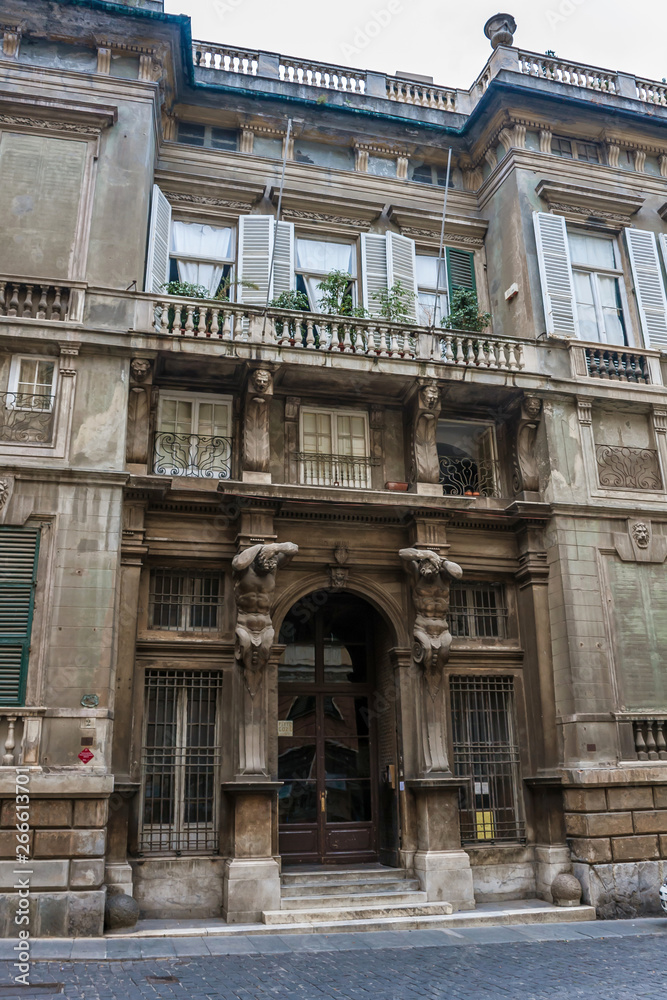 A decorated facade of an old building in Genoa