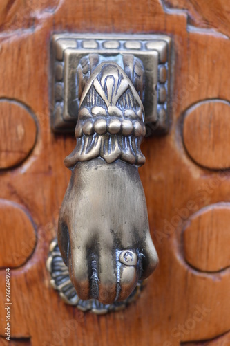 Bild auf Leinwand A shiny old door knop made of shiny metal in form of a hand.