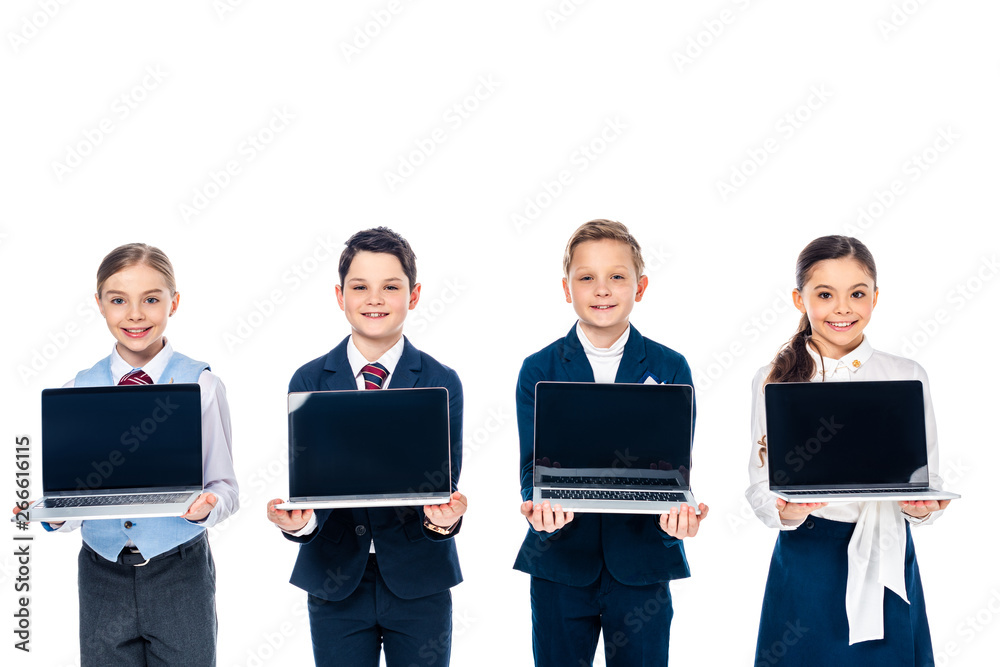 schoolchildren pretending to be businesspeople holding laptops with blank screen Isolated On White schoolchildren pretending to be businesspeople holding laptops with blank screen Isolated On White