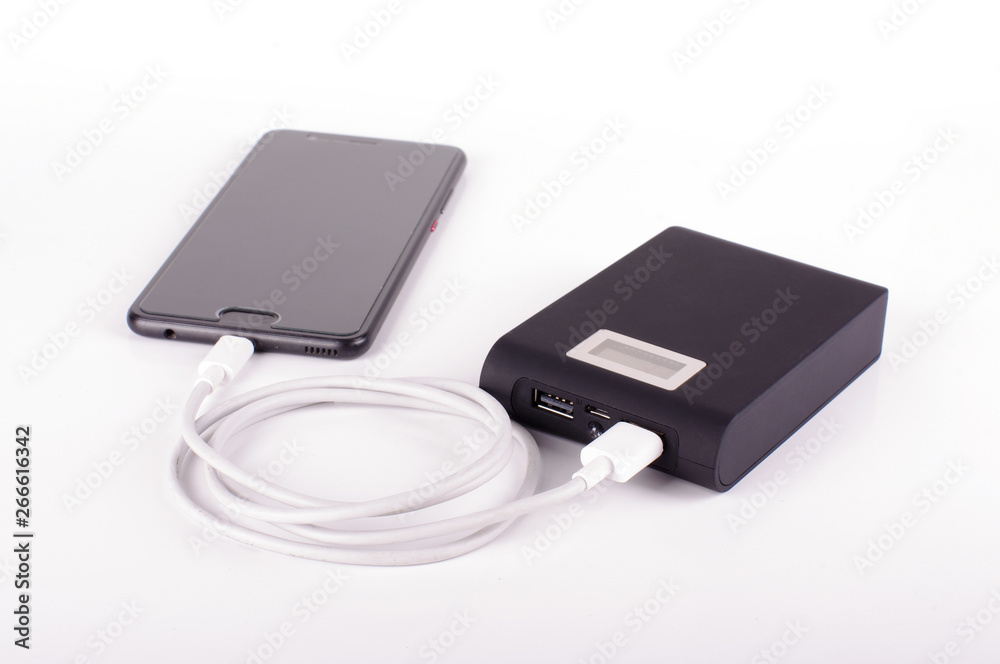 Smart phone charging from power bank isolated on the white background Smart phone charging from power bank isolated on the white background