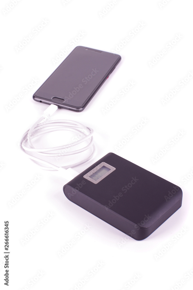Smart phone charging from power bank isolated on the white background Smart phone charging from power bank isolated on the white background