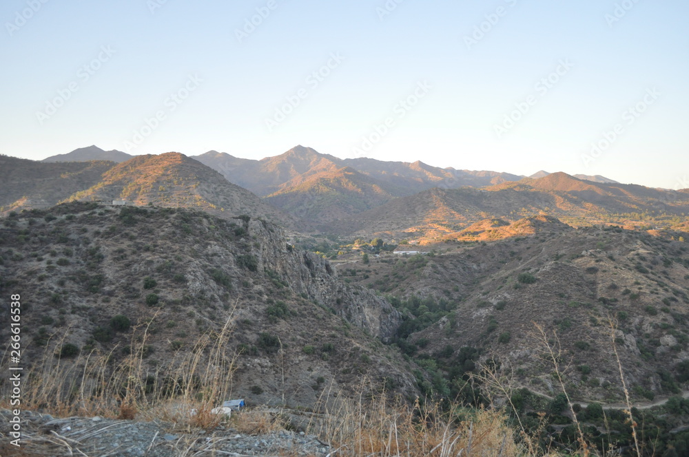 The beautiful natural mountain landscape in the Cyprus massif in the background at sunset The beautiful natural mountain landscape in the Cyprus massif in the background at sunset