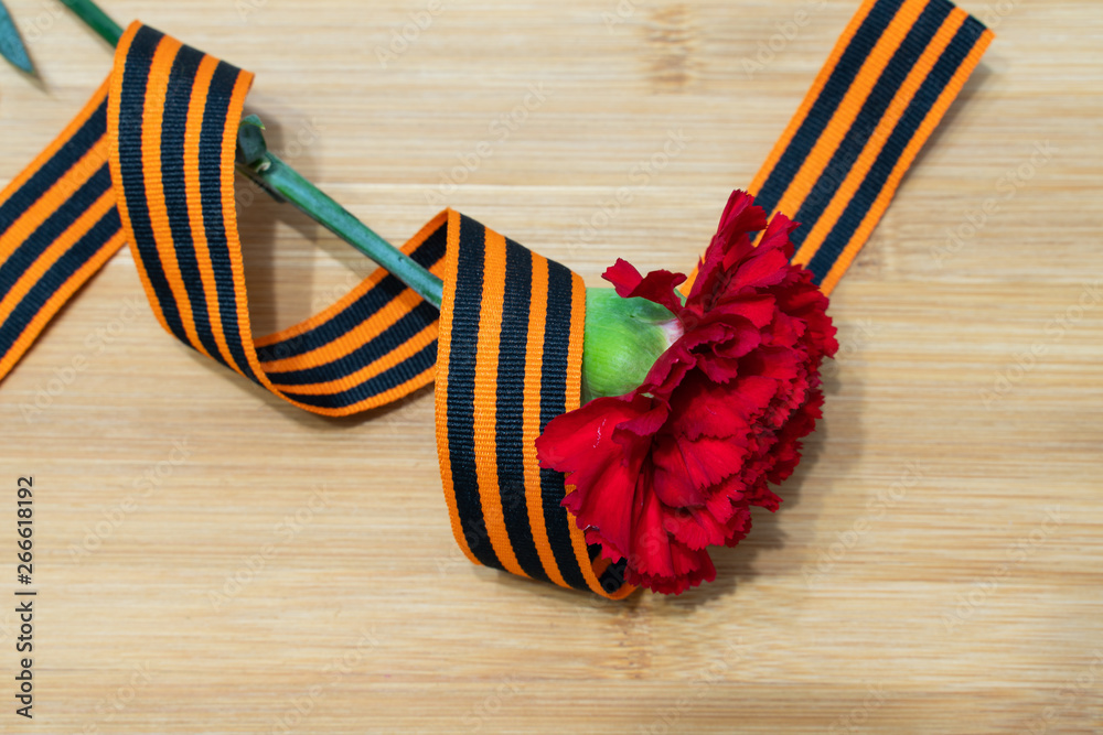 carnation and St. George ribbon on wooden background as greeting cards carnation and St. George ribbon on wooden background as greeting cards