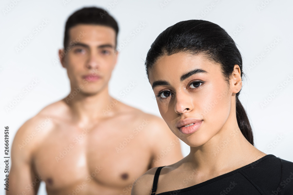 selective focus of beautiful african american girl near shirtless athletic mixed race man on white selective focus of beautiful african american girl near shirtless athletic mixed race man on white