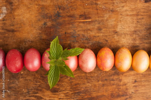 Easter eggs on a wooden background. Happy easter. Bright multicolored shiny easter eggs. Copyspace. Background with easter eggs. Place for text