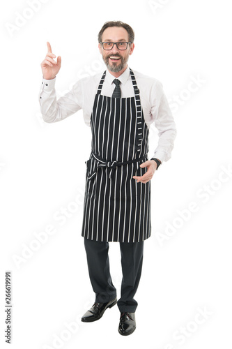 Bearded man in apron salesman. Master of household. Home cooking. Household duties. Helpful husband concept. Share household responsibilities. Ready to help. Cook barber or seller wearing apron