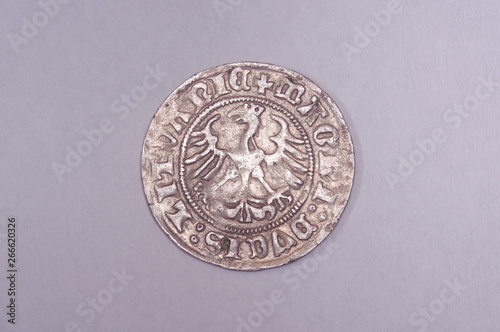 Ancient Grand Duchy of Lithuania coin half-grosz isolated on the gray background photo