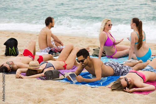  People sunbathing on the beach
