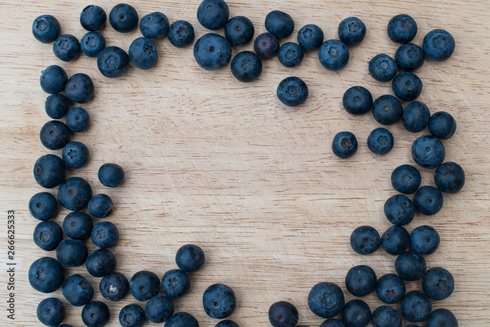 Blueberries on a wooden background. Blue berries, healthy food on dark table mockup, berry for smoothie on vintage rustic country board, copy space for text Blueberries on a wooden background. Blue berries, healthy food on dark table mockup, berry for smoothie on vintage rustic country board, copy space for text