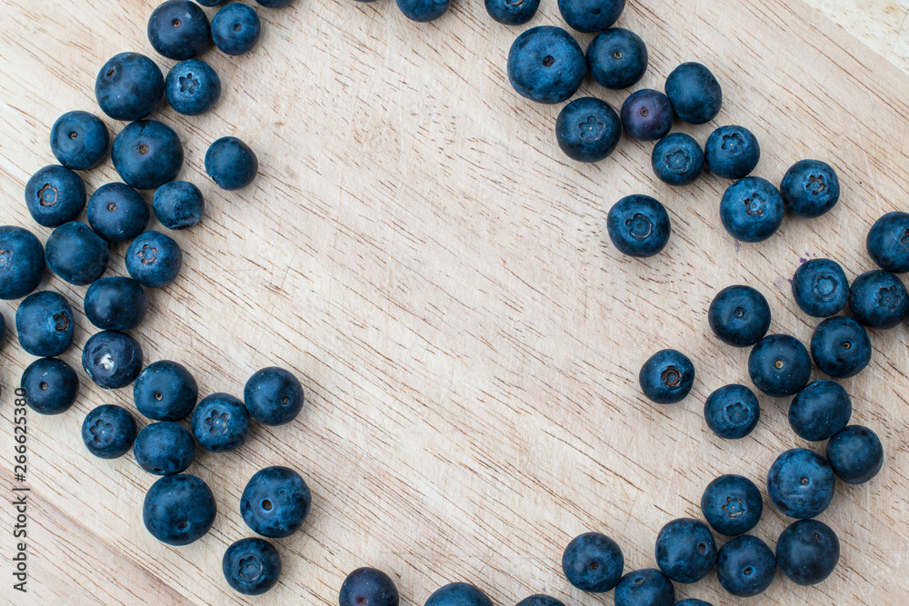 Blueberries on a wooden background. Blue berries, healthy food on dark table mockup, berry for smoothie on vintage rustic country board, copy space for text Blueberries on a wooden background. Blue berries, healthy food on dark table mockup, berry for smoothie on vintage rustic country board, copy space for text