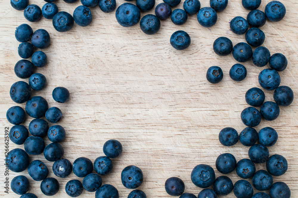Blueberries on a wooden background. Blue berries, healthy food on dark table mockup, berry for smoothie on vintage rustic country board, copy space for text Blueberries on a wooden background. Blue berries, healthy food on dark table mockup, berry for smoothie on vintage rustic country board, copy space for text