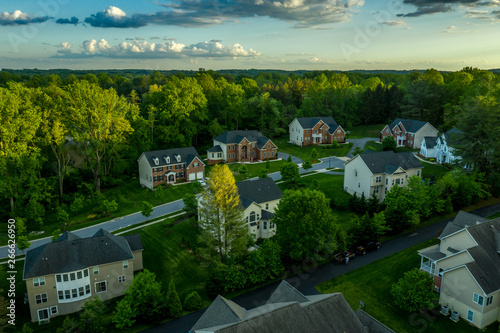 American luxury real estate single family houses with brick facade and two car garages in a new construction Maryland street neighborhood USA aerial view photo