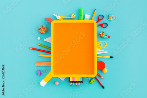 Creative flat lay with school supplies around copy space. Top view.	 photo