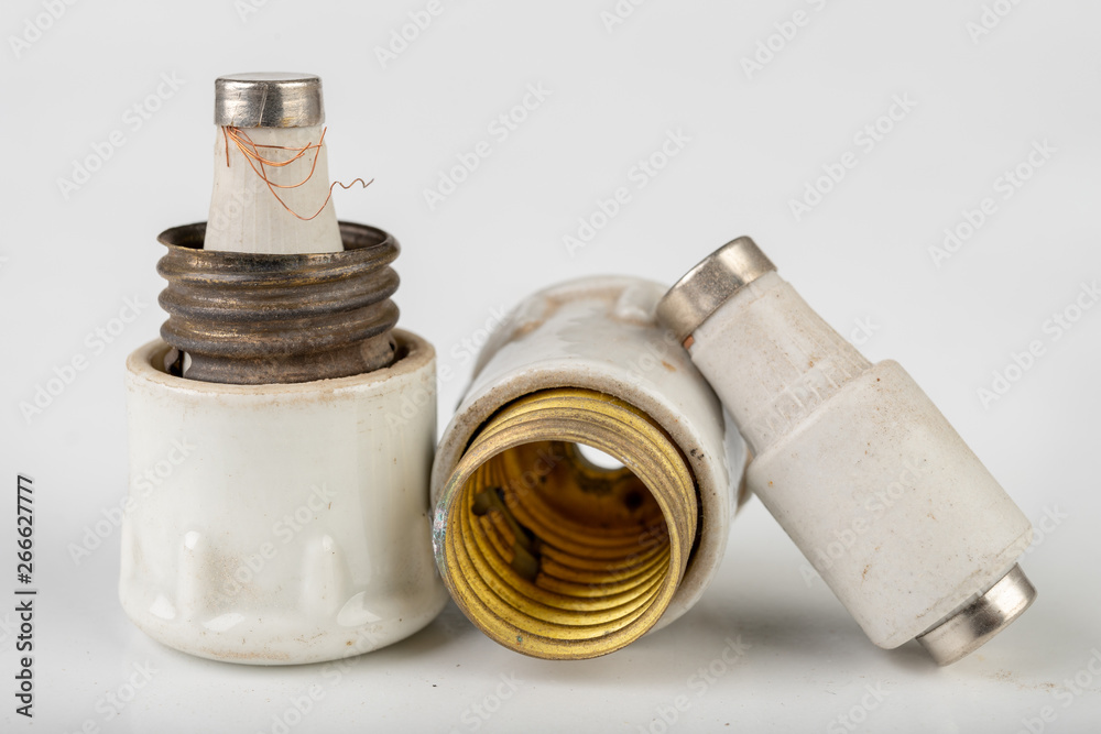 Old ceramic electric fuse. Blown and badly repaired security for energy ...