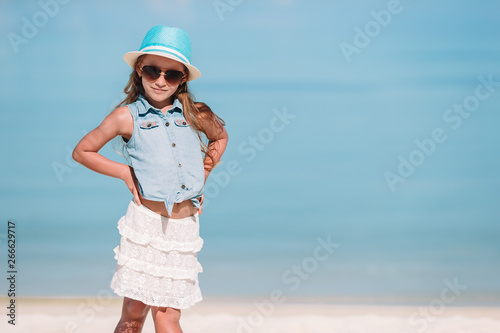 Portrait of adorable little girl at beach during summer vacation © travnikovstudio