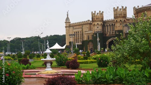 day time famous bangalore city palace front garden slow motion fountain panorama 4k india photo