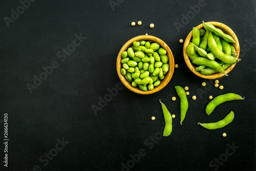 vegan food with green soybeans or edamame on black background top view copy space photo