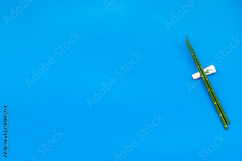 bamboo sticks for sushi and maki on blue background top view mockup