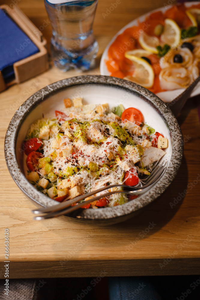 Caesar salad with parmesan and crunchy bread creakers in a big bowl in a restaurant buffet Caesar salad with parmesan and crunchy bread creakers in a big bowl in a restaurant buffet