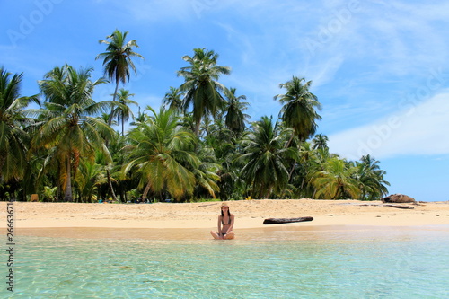 Young beautiful woman enjoying her time and resting close to the sea in the southern beach of 