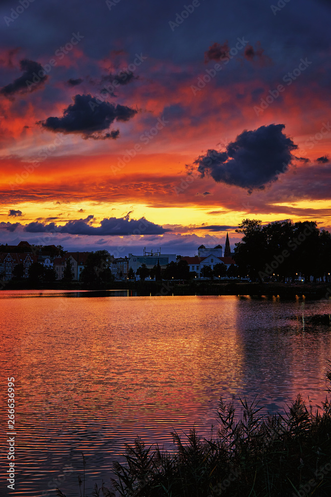 Dramatic sunset with clouds over the Schwerin old town. Mecklenburg-Vorpommern, Pomerania, Germany