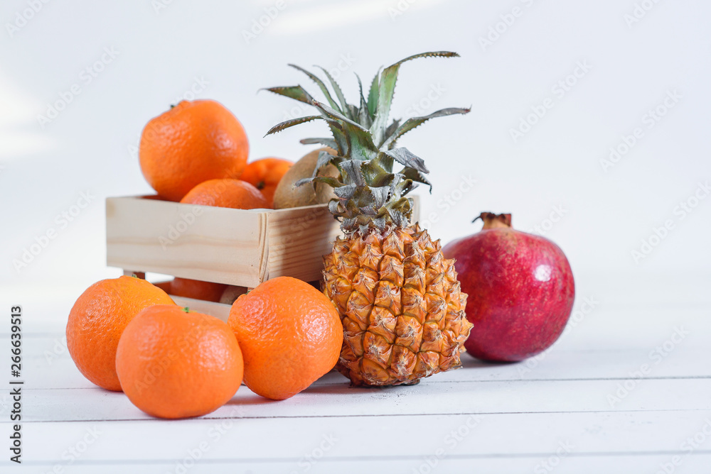 Group of fresh tropical fruits in small wooden box. Group of fresh tropical fruits in small wooden box.